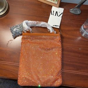 A NWT orange beaded bag.